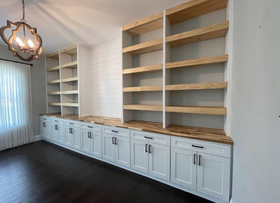 Custom built-in bookshelves and lower cabinets with wooden countertops, expertly crafted by Midwest Home Remodeling & Design LLC in Chicago, IL.