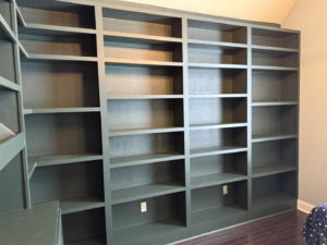 Custom built-in bookshelves painted dark green, installed by Profix Home Repair in Jonesboro, AR.