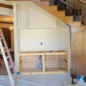 Custom built-in cabinet framing under a staircase by M&M Drywall and Construction in Enid, OK