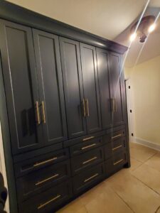 Custom built-in cabinets with gold hardware for storage by APJ Construction Inc. in El Paso, TX.