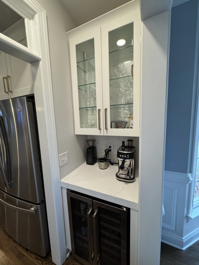 A custom built-in coffee bar and beverage station with white cabinets installed by Branch Home Improvement LLC in Raleigh, NC.