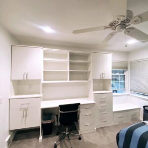 A custom built-in desk and shelving unit in a home office or bedroom by Closet Creations Inc. in Sleepy Hollow, NY.