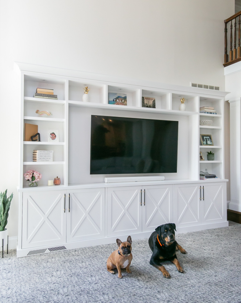 A custom white built-in entertainment center with shelving and cabinets installed by TCS Woodworking in Baltimore, MD