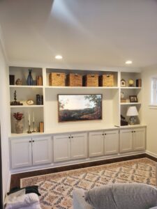 Custom built-in media center with shelving and cabinets in a living room by Corkery Customs & Remodeling LLC in Philadelphia, PA