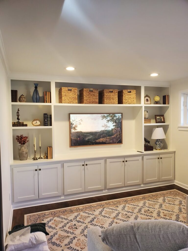 Custom built-in media center with shelving and cabinets in a living room by Corkery Customs & Remodeling LLC in Philadelphia, PA