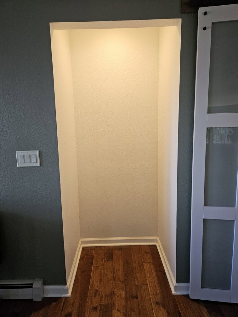 Custom built-in niche with integrated lighting and new flooring by Denver House Repair in Lakewood, CO.