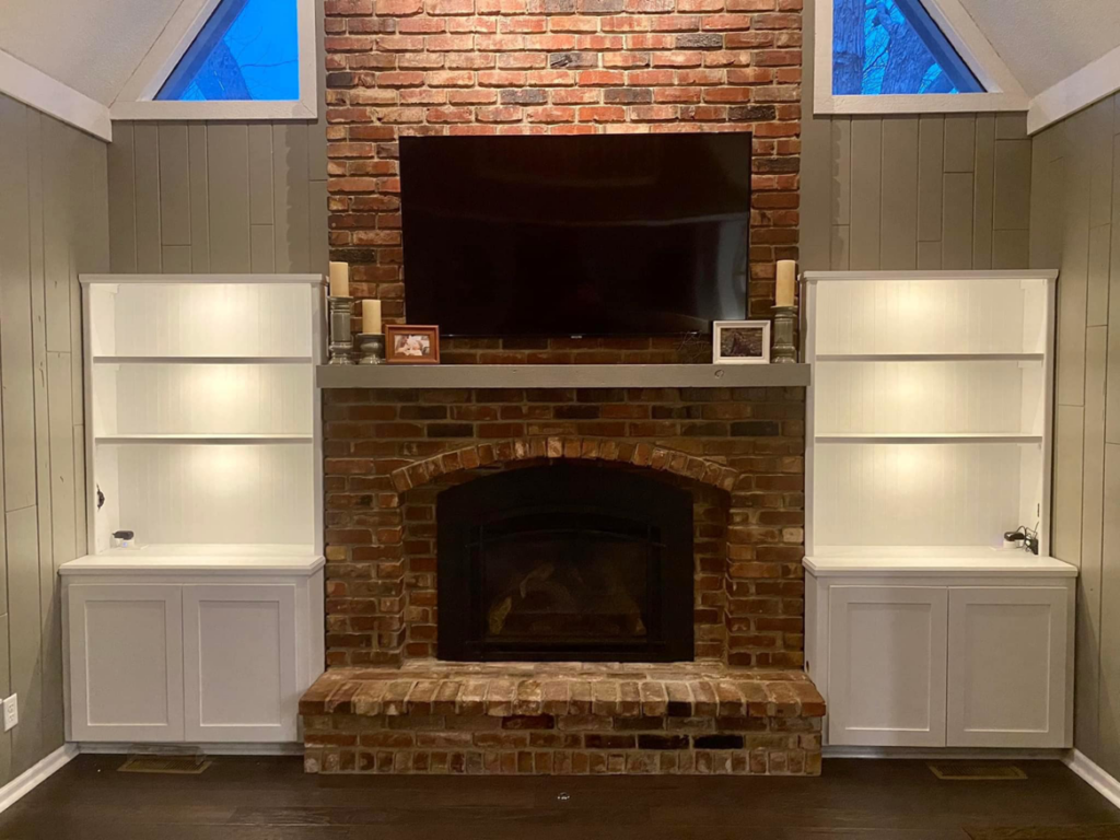 Custom built-in bookshelves installed on either side of a fireplace by Norbe's Home Solutions LLC in Lenexa, KS.