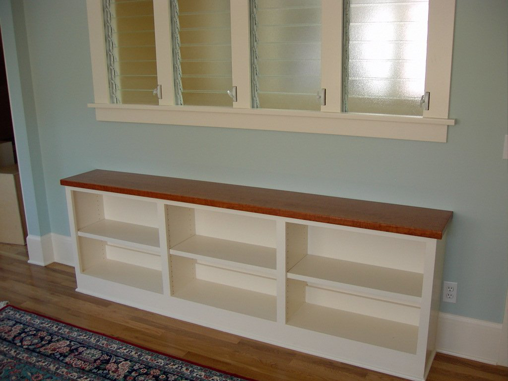 A custom-built low bookshelf or cabinet with a wooden top by Hessel Carpentry in Portland, OR.