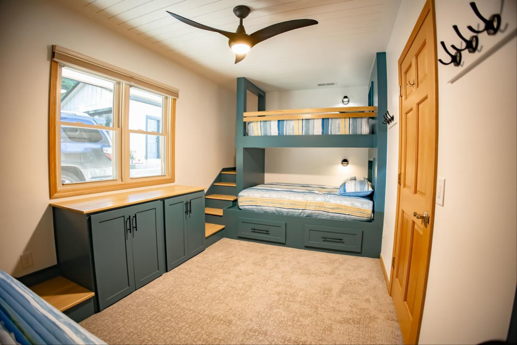 A full room view showcasing custom bunk bed installation, built-in storage, and ceiling fan by An Extra Hand in Indianapolis, IN.