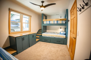 A full room view showcasing custom bunk bed installation, built-in storage, and ceiling fan by An Extra Hand in Indianapolis, IN.