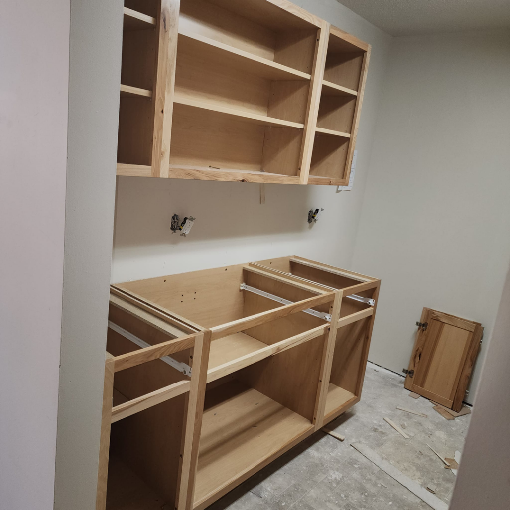 Custom wooden cabinets being installed in a home by Excalibur Home Services, providing handyman services in Council Bluffs, IA.