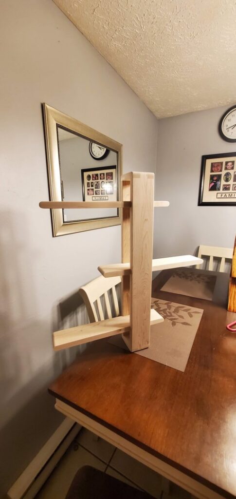 A custom-built white cabinet with sliding barn doors and a wooden top, crafted by Dovetails Services LLC in Derry, NH.
