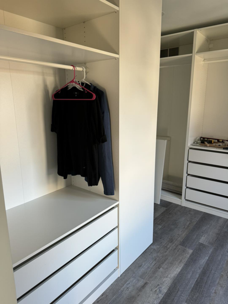 A custom closet system with white shelving and drawers installed by Strausbaugh Construction Services LLC in Cincinnati, OH.