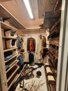 Custom-built closet with wooden shelves and hanging rods installed by SAM'S Handywork LLC in Independence, IA.