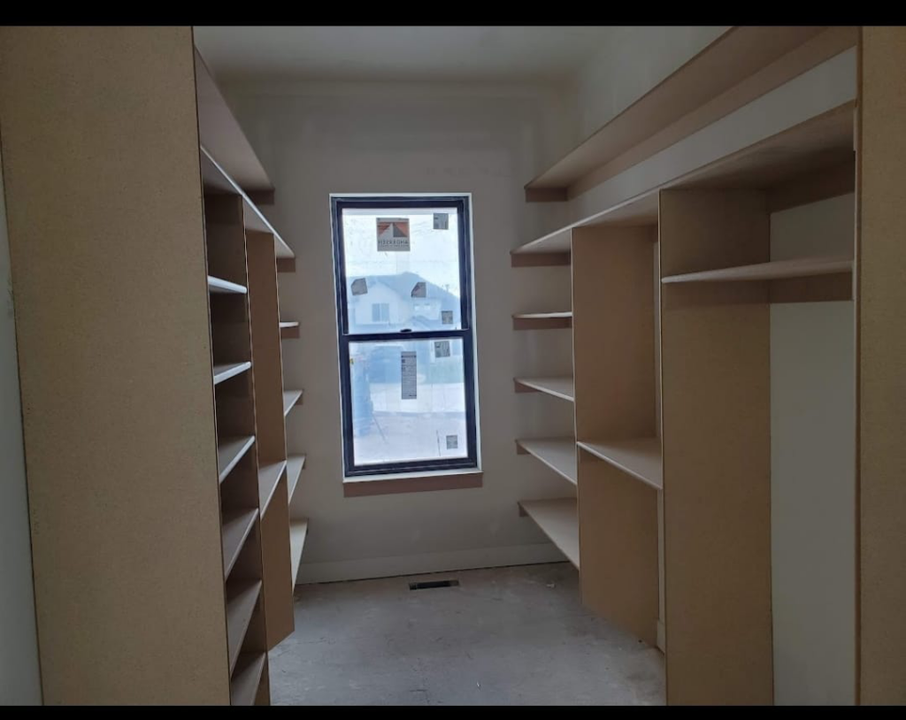 A custom wooden closet shelving system installed by Blue Ridge Customs LLC in a Raleigh, NC residence.