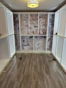 Custom closet shelving with decorative wallpaper accent wall installed by CWS Handyman LLC in Seekonk, MA