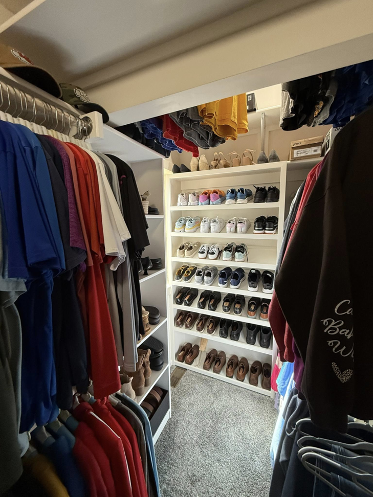 A custom closet featuring shoe racks and shelving for optimal organization by M Squared Construction LLC in Tonganoxie, KS.