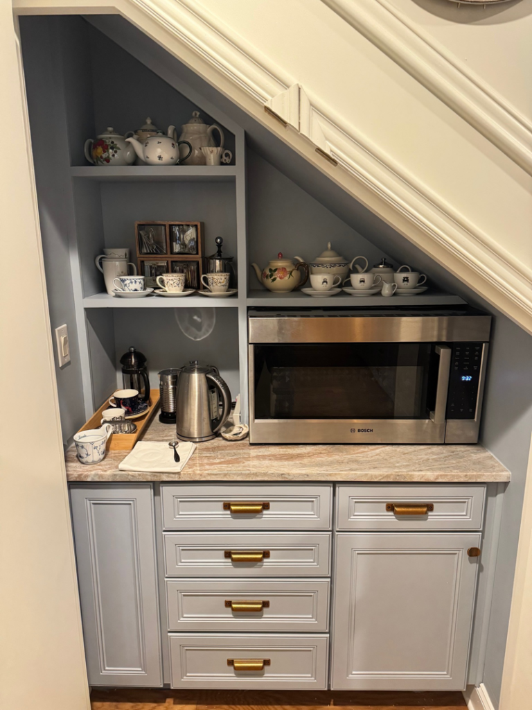 Custom coffee bar and microwave nook installed under a staircase by DeWitt Endeavors in Lexington, KY