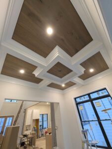 Custom coffered ceiling installation with wood panels and trim by Roche Painting in Allentown, PA.