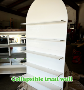 A custom-built white collapsible treat wall with shelves by Peak Handyman Services in Las Vegas, NV.
