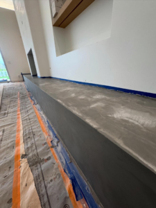 A custom concrete coating project in progress with protective sheeting by Orange Door Custom Coatings in Phoenix, AZ.