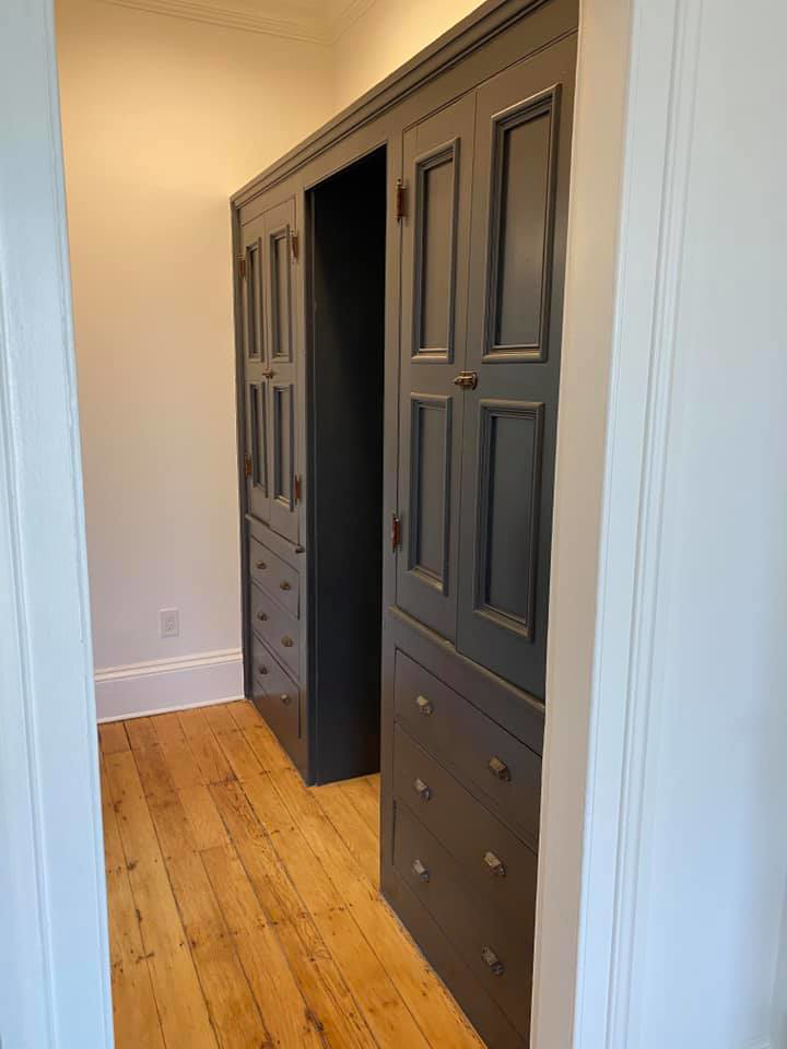 Custom dark grey built-in cabinetry with multiple doors and drawers, crafted by MTI Carpentry in Jersey City, NJ.
