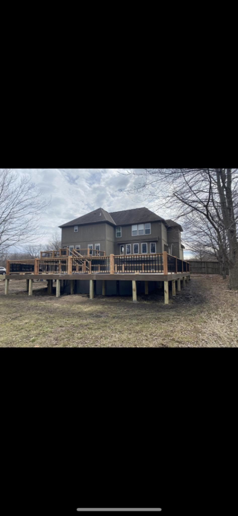 Custom deck construction around a house, showcasing the expertise of Chad Fry the Deck Guy LLC in Blue Springs, MO.