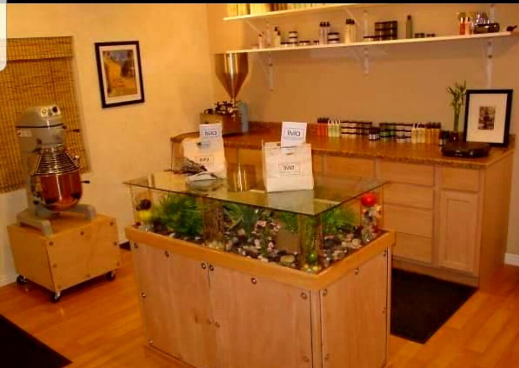 A room with a custom glass-top display case and shelving installed by Halpin Hands in Williams, OR.