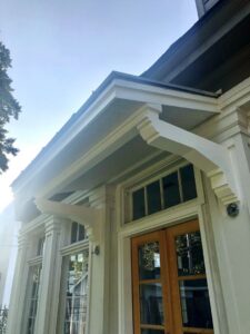 A custom-built decorative portico installed above an exterior door by Custom Carpentry Service in Knoxville, TN.