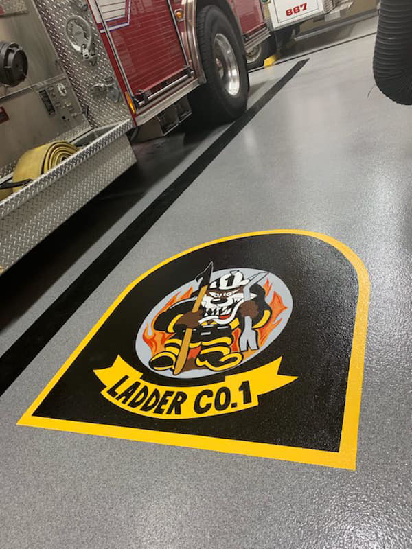 Custom Ladder Co. 1 epoxy floor graphic installed in a fire station by Blendex Industrial Epoxy Floors in Lindenhurst, NY