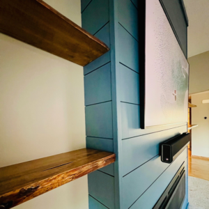 Close-up of custom feature wall with shiplap paneling and floating wooden shelves by Med City Handy Ma'am in Rochester, MN