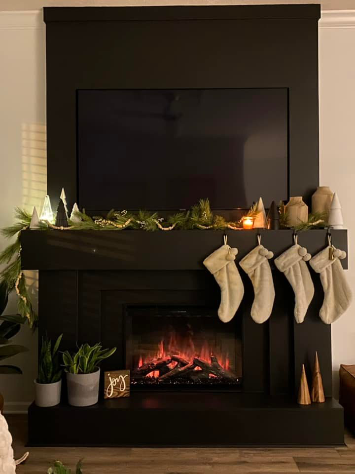 A custom-built fireplace surround with a built-in TV enclosure by Shawn's Handyman Services in Fishers, IN.