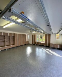 An organized garage with custom cabinets, shelving, and epoxy flooring installed by PremierGarage of Baltimore in Baltimore, MD.