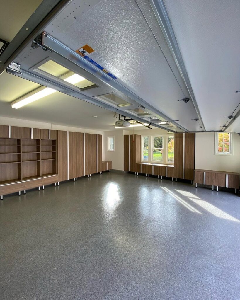 An organized garage with custom cabinets, shelving, and epoxy flooring installed by PremierGarage of Baltimore in Baltimore, MD.
