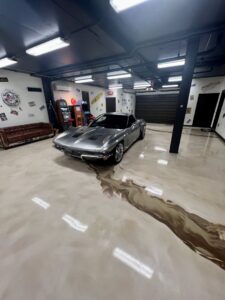 A custom garage featuring a metallic epoxy floor and a classic car, completed by Floor Coating Specialist in St. Petersburg, FL.