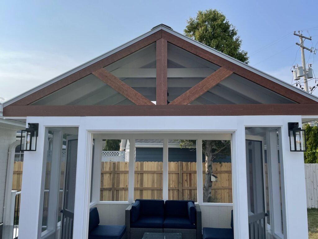 Custom-built gazebo with screened walls and wooden beams by Top Notch Contracting in Racine, WI.