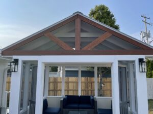 Custom-built gazebo with screened walls and wooden beams by Top Notch Contracting in Racine, WI.