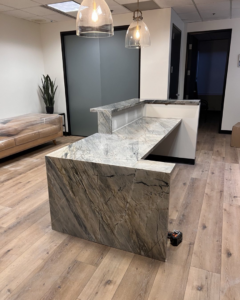 A newly installed custom granite reception desk in an office by AZ Custom Granite in Glendale, AZ.