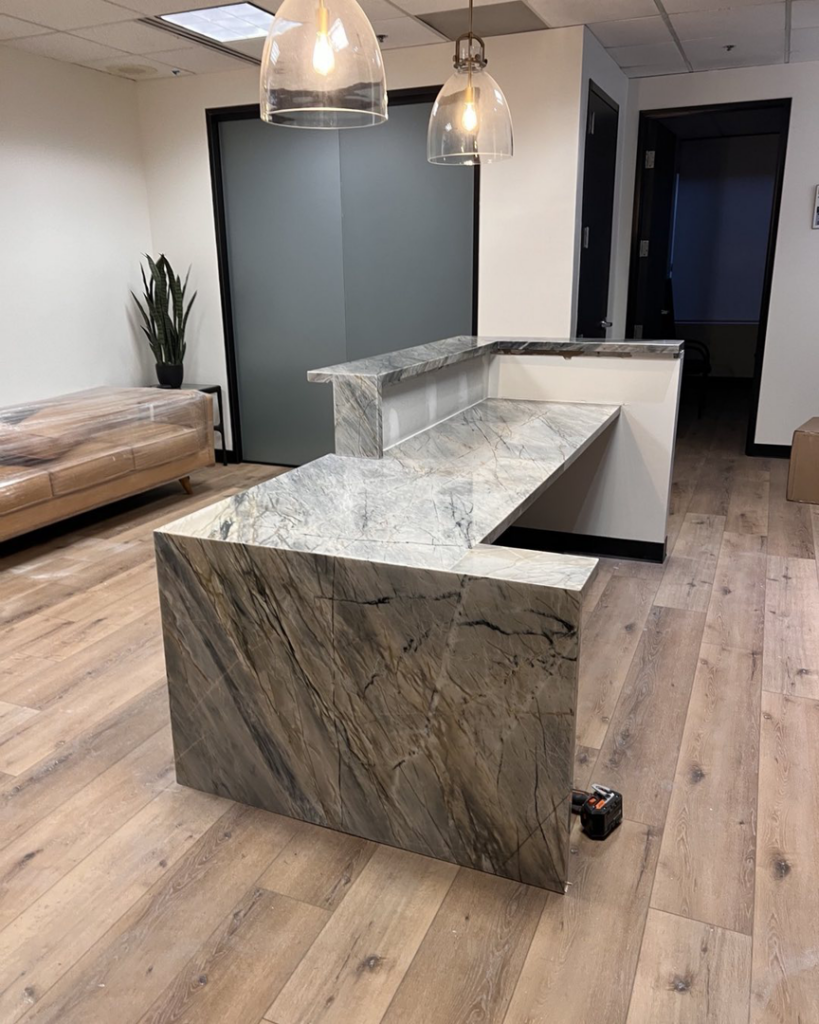 A newly installed custom granite reception desk in an office by AZ Custom Granite in Glendale, AZ.