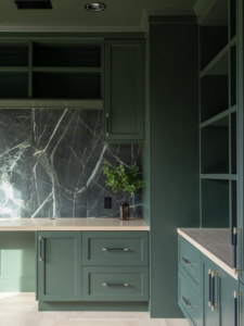 Custom dark green cabinets and a marble backsplash installed by JDI Construction in Vancouver, WA.