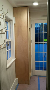 Custom hallway cabinet installation with coat hooks by Thomas J Stone GC in Yonkers, NY