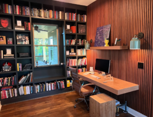 A custom-built home office with extensive bookshelves and a floating desk by Special Reserve Contracting in Charlotte, NC.