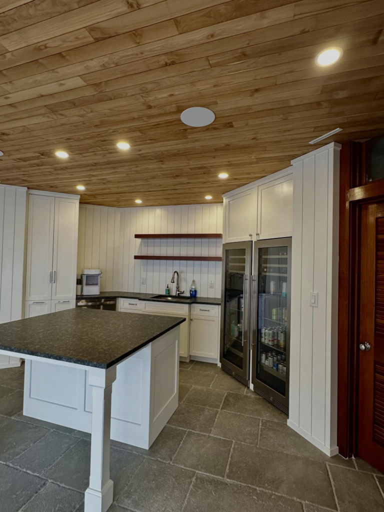 Custom kitchen or bar area featuring white cabinets, an island, and a wood ceiling by Lardieri's Custom Woodworking Company, Inc. in Lakewood, NJ.