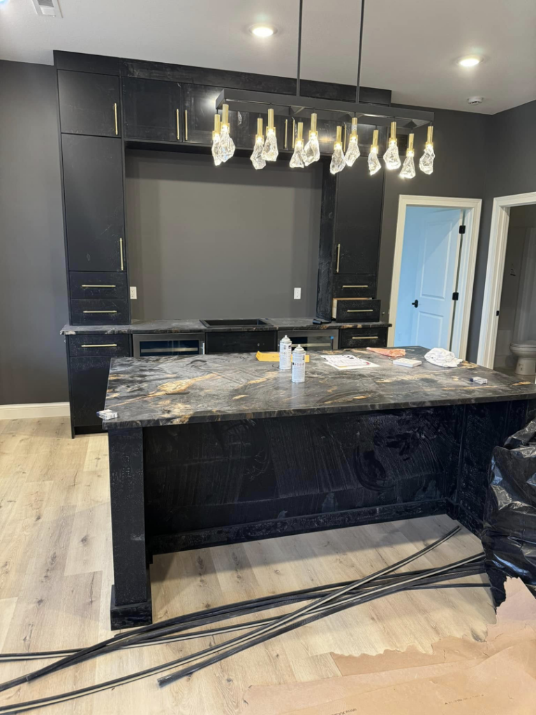 Custom kitchen island and cabinetry installation in progress by Rave Homes - Missouri in Columbia, MO.