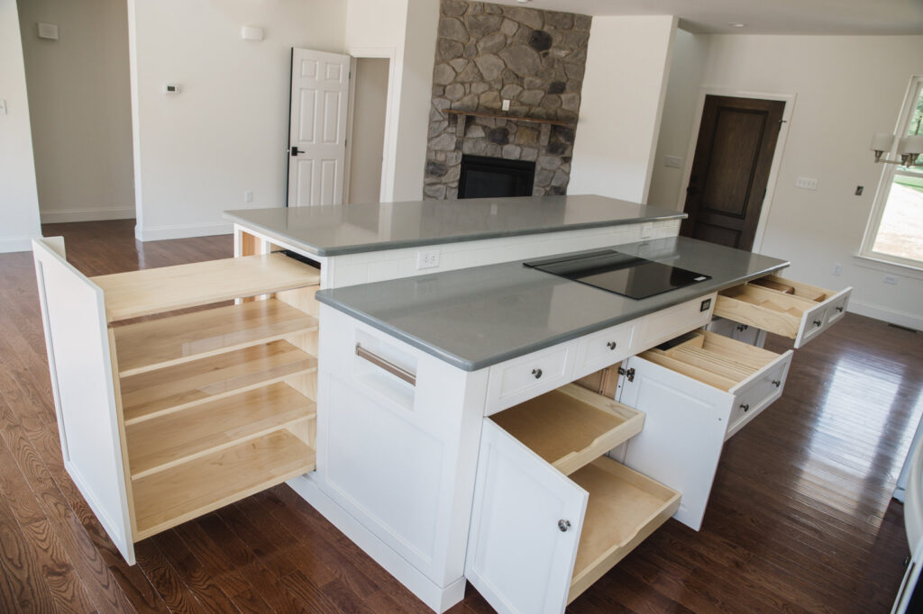 A custom kitchen island with pull-out drawers and shelving, demonstrating storage solutions by Corrado Custom Homes, Inc. in Kutztown, PA