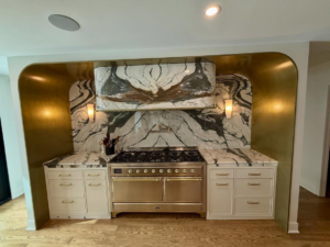 Detailed view of a custom kitchen range area with marble backsplash and cabinetry by Red Beard Cabinets in Kansas City, MO.