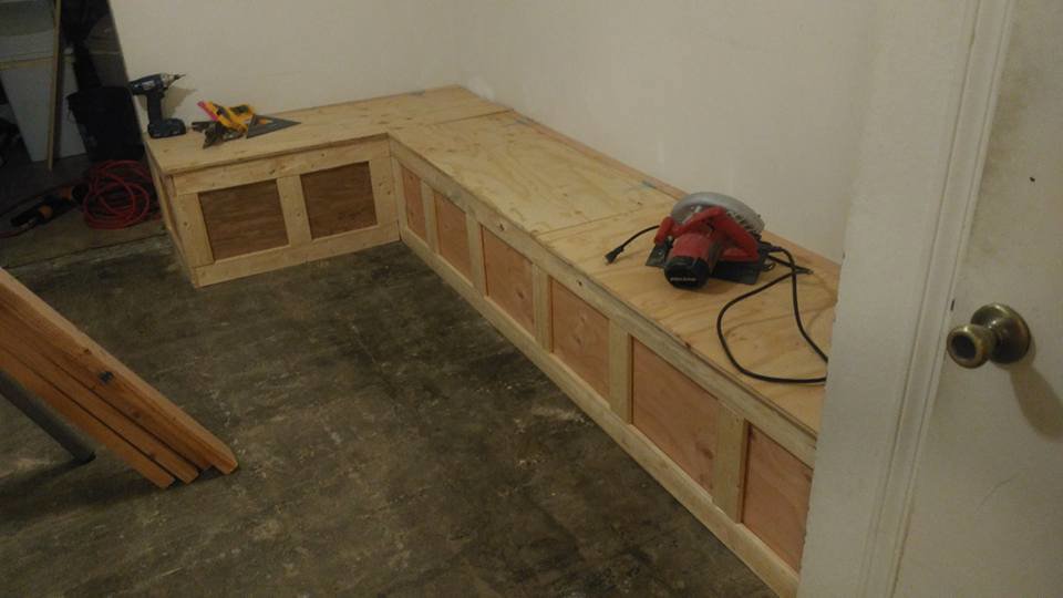 A custom L-shaped wooden bench or storage unit being built, demonstrating carpentry services by MG'S Services LLC in Albuquerque, NM.