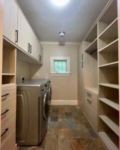 Custom cabinets and shelving installed in a modern laundry room by Closet Creations Inc. in Sleepy Hollow, NY.