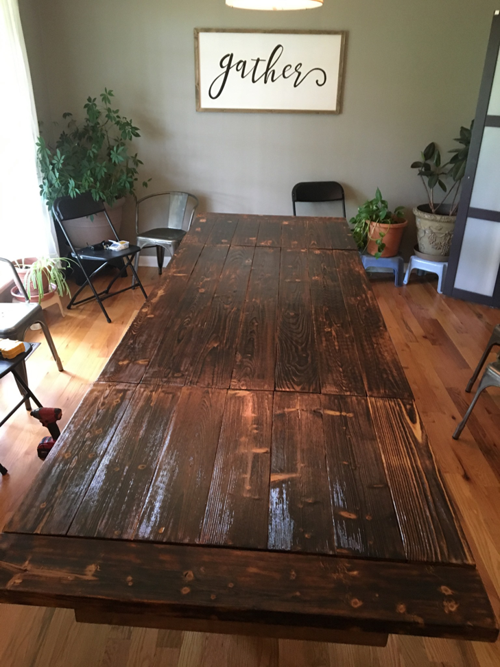 A custom-built long wooden dining table with a dark stain, crafted by Davidson Handyman Services in Nashville, TN.