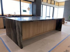 A kitchen showcasing a custom marble range hood and matching countertops installed by Oddonetto Granite & Marble LLC in Phoenix, AZ.